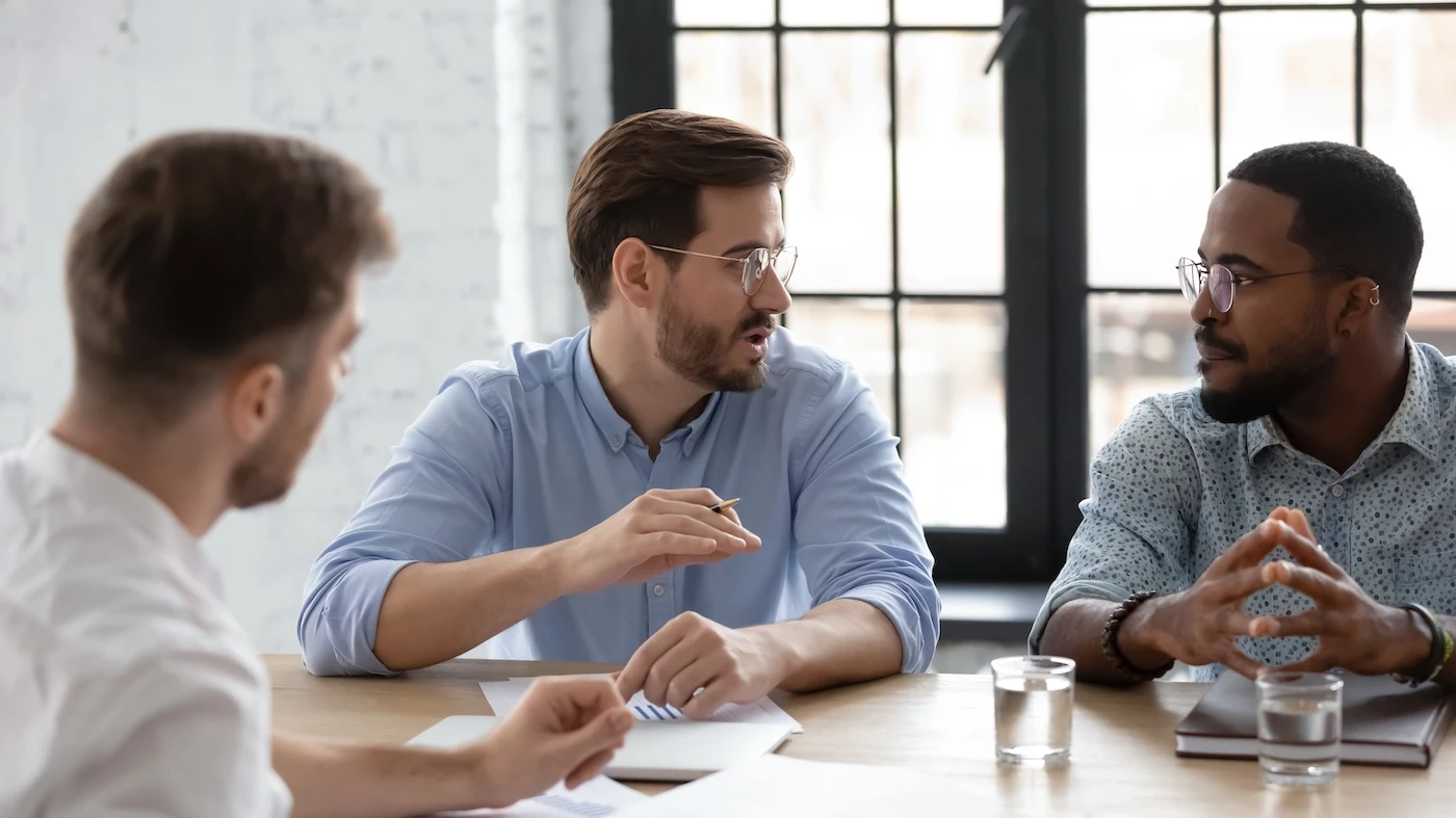 Diverse team discussing project strategy, sales and marketing reports on corporate meeting in office. Male leader and his group talking and brainstorming together. Coach training multiethnic employees SSUCv3H4sIAAAAAAAACpxTy2rkMBC8L+w/DDpHoKcl5VeWPejlGRGPFWQ5IYT8e9rPaPa4GIy7Wl1dXWp//v51uSBnp+TR8+VziSBOwzBPtdia8ggwedrxEscQS4u8Fd6RFogh1VySHVrQ2epvo71HAMd5GBb4a02iqdo6T3Fauu+QtzVegWMDT4pN4p8tvhyJNQkVkELoqcGm2a3YAW3k/1W5ffw9prHXOPqPH20AhRLtfappnfCUCAklH6gpYw+xMmeXg35pMNj7xz9ED2WdY0byoDDTmmFBpMGOcIMDUyZoTil34Yd4+1in2B0ucYh2M33vgaTi2hjhcdCRYKECwTYEg3XUXLioteP00ICYC4701GABKXiFgK2THnciUskik6GL52FJmded0pixzoFY7UGsUDhyz4XpmbFcrmI3B9DLe43l3i6EnUPKzS68ZW+H5QBvZnotyafx2pTleluX9SjzeR5rWYw93URDzq/WDcu19cAZD/xmpwmOhwNvGnn4NfK96TPmulq5s6IA+7uElLOOE6UMFwweTva733f+loBnlXMQQexfUmhHT4sC5B3vBZUELLQKC+87uBxGMaVWSdOD7YaBhV/fAAAA//8DANgeqNnOAwAA